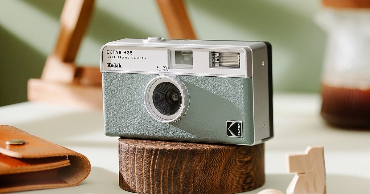 A Sage Green Kodak H35 Half-Frame Film Camera on a block of wood
