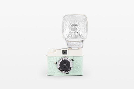 Lomography diana mini 35mm camera in teal and white picnic front view